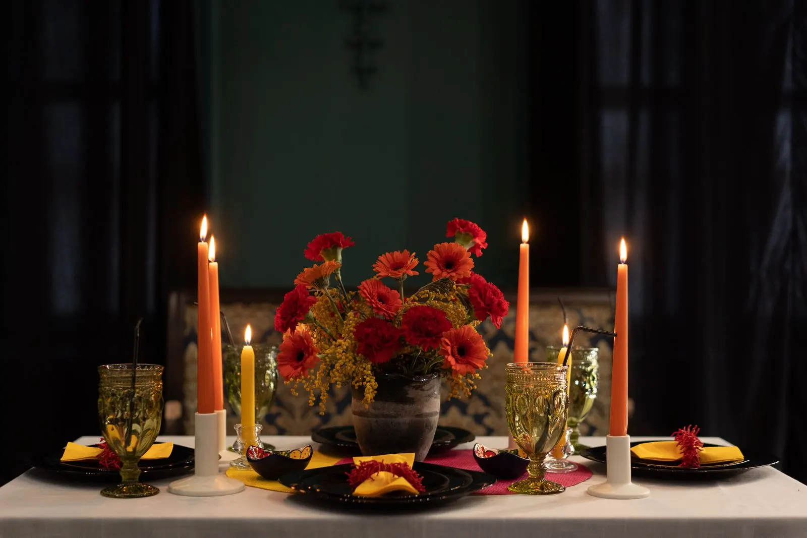 The long table laid for dinner by candlelight