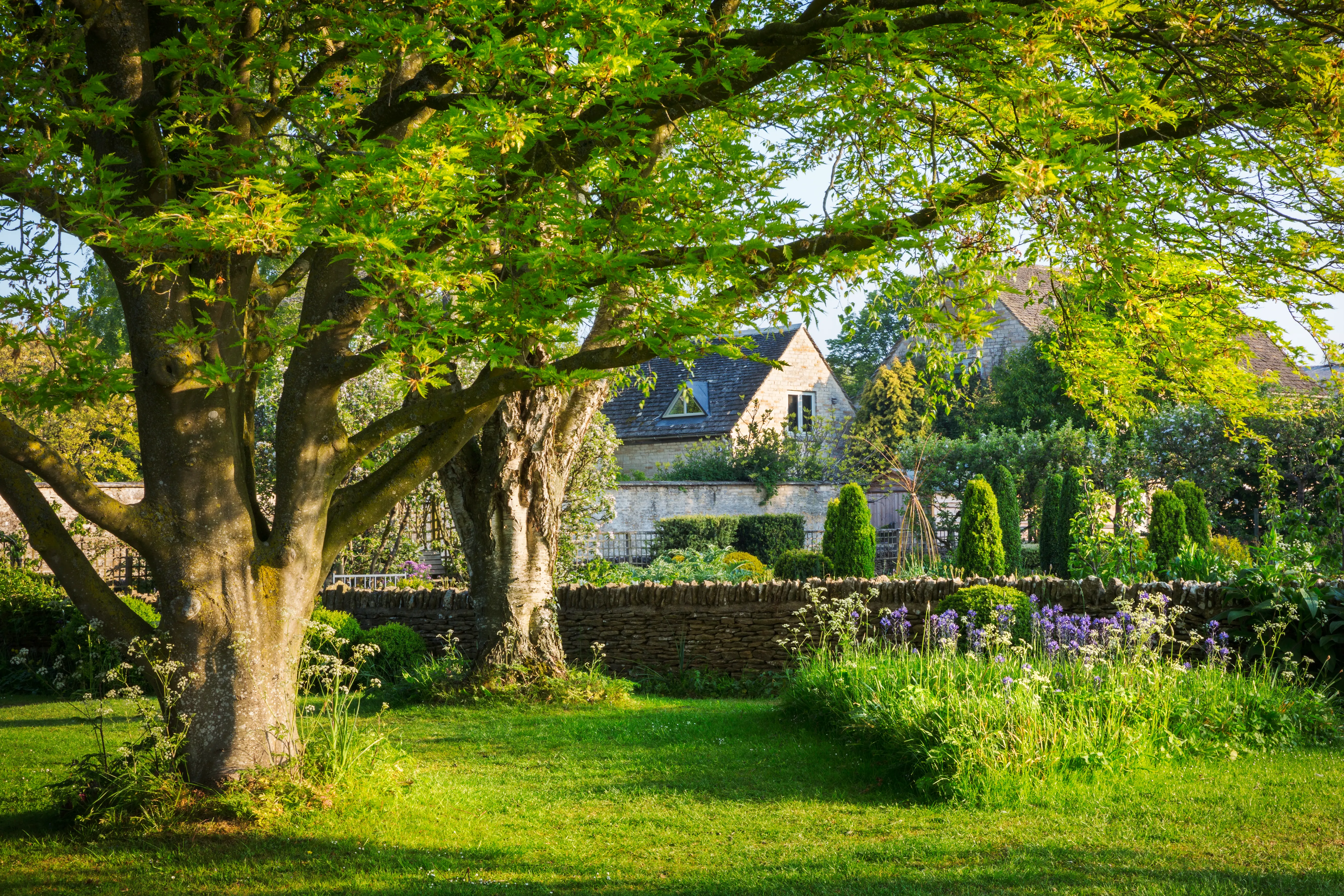 The walled garden at Eldermere, lawns edged with deep borders
